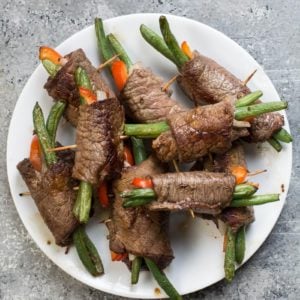 These easy Keto Steak Rolls are loaded with flavor. Flank steak is wrapped around green beans, peppers and onion, just 4 net carbs per serving! #keto