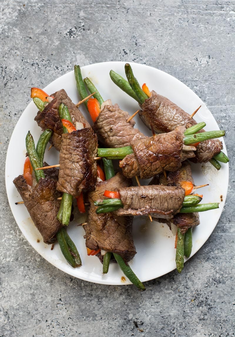 These easy Keto Steak Rolls are loaded with flavor. Flank steak is wrapped around green beans, peppers and onion, just 4 net carbs per serving! #keto