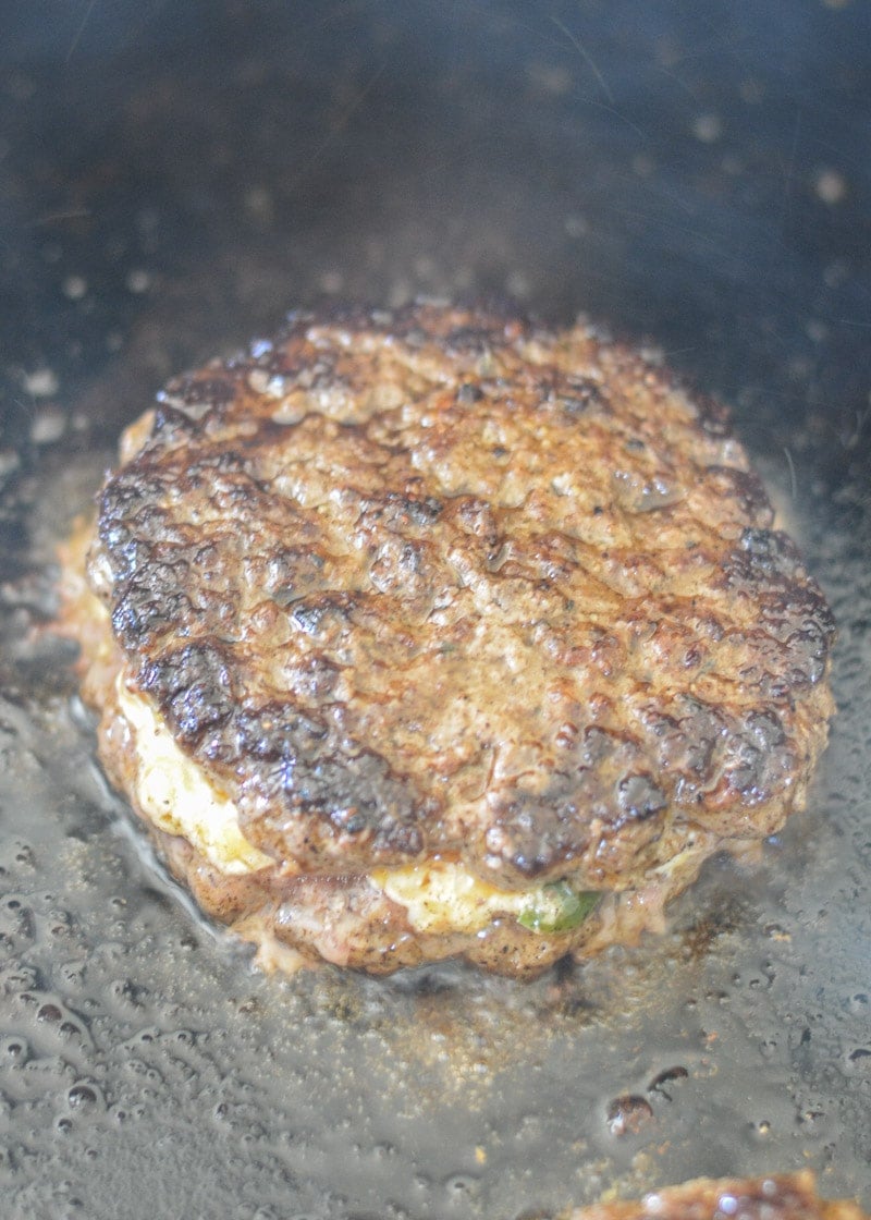 Keto Jalapeño Popper Burgers are the ultimate low carb dinner! Juicy burgers are loaded with creamy jalapeño popper filling and served on crispy chaffle buns!