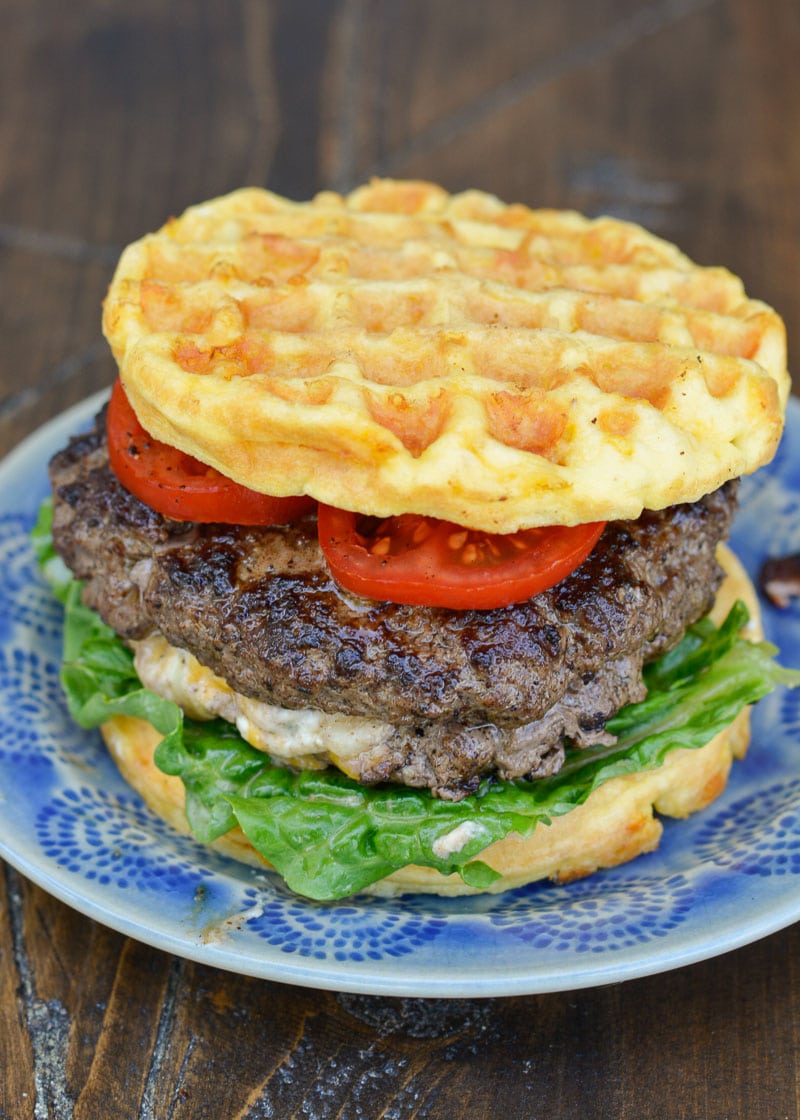 Keto Jalapeño Popper Burgers are the ultimate low carb dinner! Juicy burgers are loaded with creamy jalapeño popper filling and served on crispy chaffle buns!