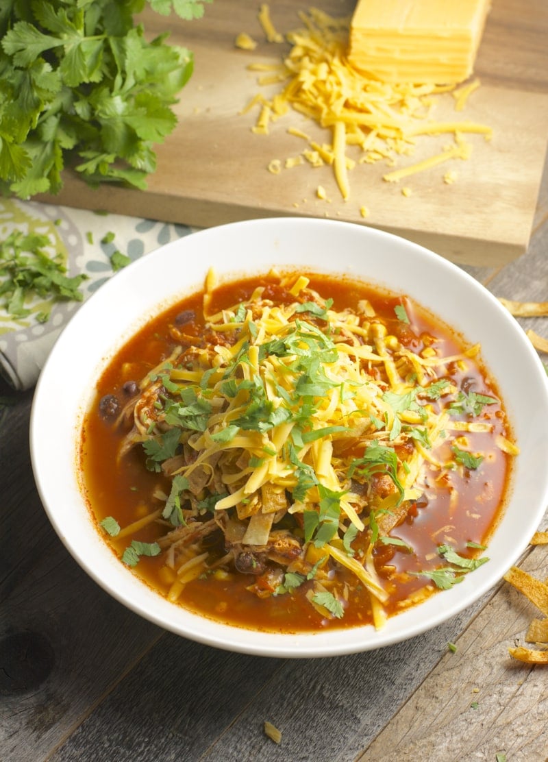 Slow Cooker Chicken Enchilada Soup, all the flavor of enchiladas in an easy healthy soup! #slowcooker www.maebells.com
