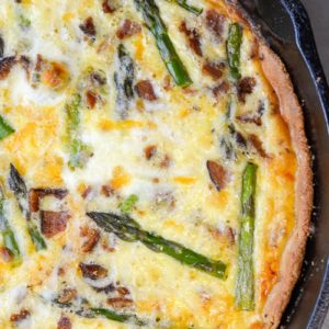 This Asparagus and White Cheddar Quiche is packed with perfectly tender asparagus, salty bacon and sharp cheddar cheese. This easy quiche recipe has options for a low carb, keto friendly crust perfect for a Spring brunch!