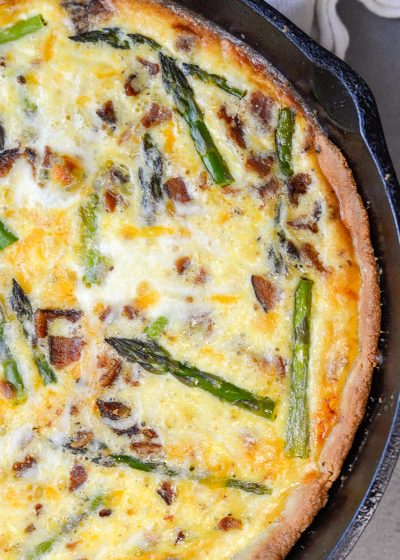 This Asparagus and White Cheddar Quiche is packed with perfectly tender asparagus, salty bacon and sharp cheddar cheese. This easy quiche recipe has options for a low carb, keto friendly crust perfect for a Spring brunch!