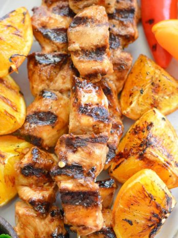 These Orange Sesame Chicken Skewers are loaded with sweet and spicy Asian flavor! Pair with grilled orange wedges for a real treat!