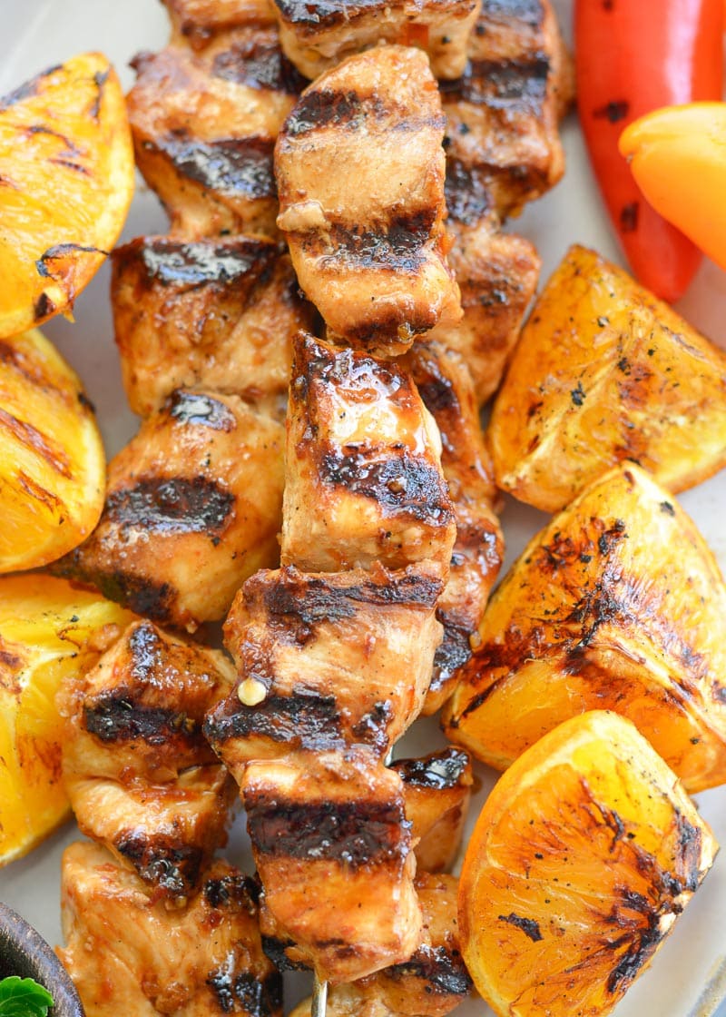 These Orange Sesame Chicken Skewers are loaded with sweet and spicy Asian flavor! Pair with grilled orange wedges for a real treat!