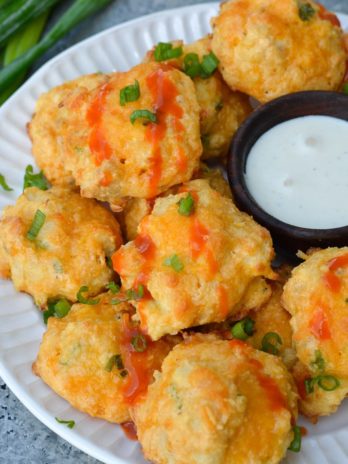 These Cheesy Buffalo Chicken Bites will be a new keto-friendly favorite! Cheesy almond flour bites are packed with spicy Buffalo Chicken for the perfect snack under 1 net carb! 