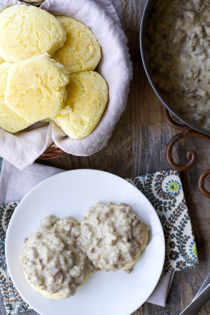 overhead view of basket of biscuits and plate of biscuits and gravy 