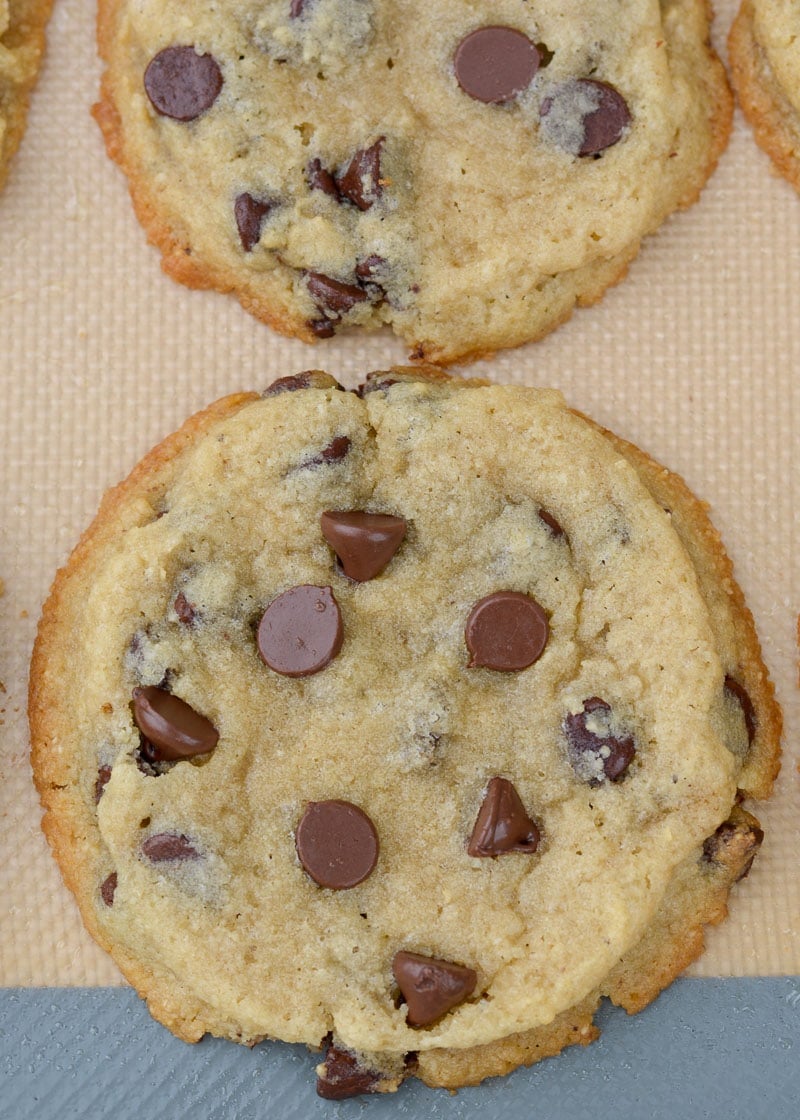 overhead closeup shot of gluten free chocolate chip cookies on a silicone baking sheet