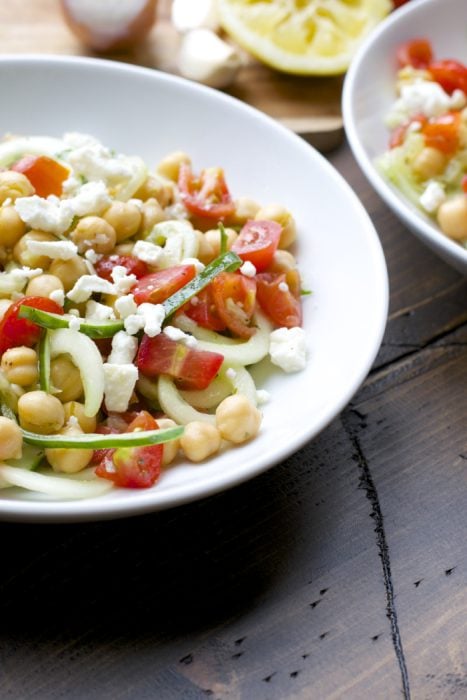 This Cucumber Chickpea Salad is packed with spiralized cucumbers, cherry tomatoes, chickpeas, feta and tossed in a simple lemon vinaigrette.