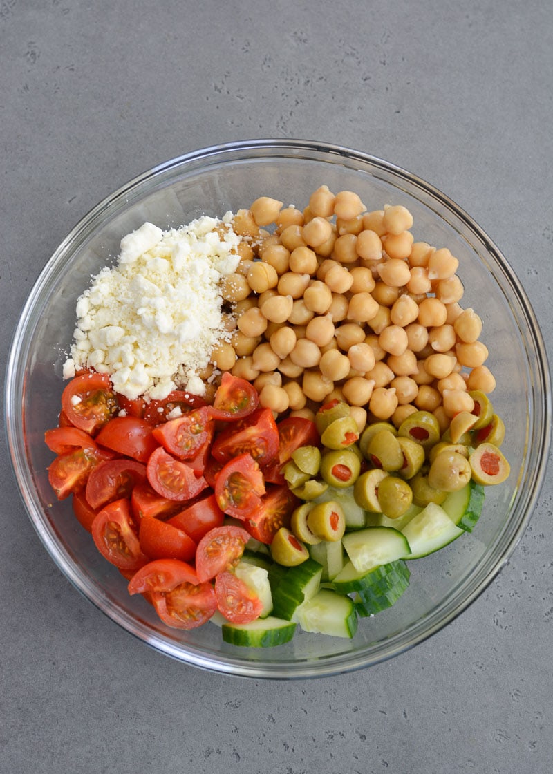 This Healthy Chickpea Salad is packed with chopped cucumbers, cherry tomatoes, chickpeas, feta and tossed in a simple lemon vinaigrette.