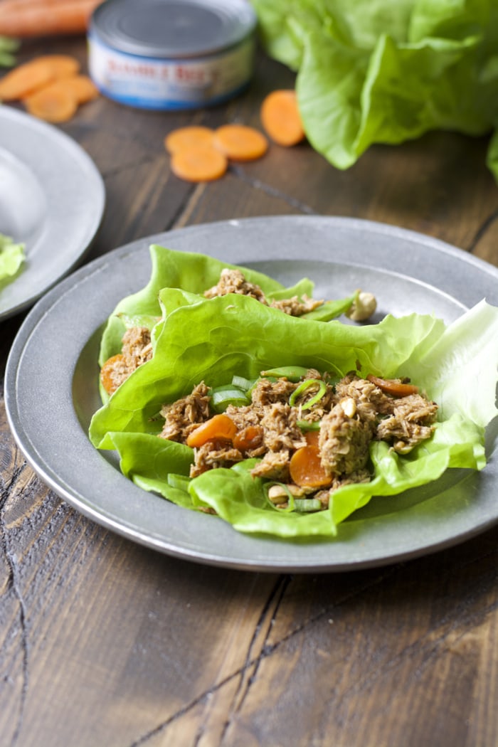 two tuna lettuce wraps on a plate. 