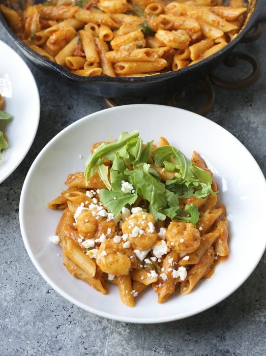 One Pan Shrimp Pasta with Feta! Ready in under 15 minutes! This simple one pan pasta dish is easy enough for a weeknight meal but fancy enough for a dinner party! And gluten free!