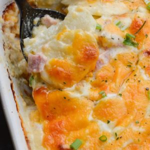 These Cheesy Scalloped Potatoes feature thinly sliced potatoes, a creamy cheddar sauce and chunks of smoked ham!