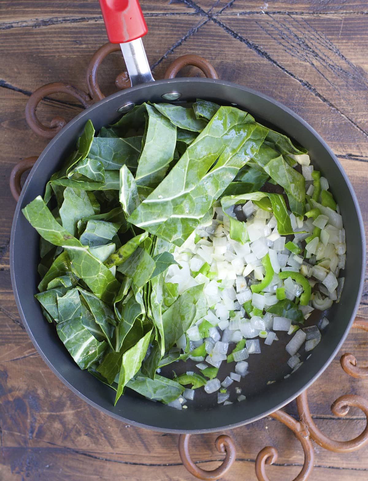 Crock Pot Black Eyed Peas and Collard Greens are the ultimate Southern comfort food! Tender greens, salty ham, and spicy jalapenos make the absolute best slow cooker meal.