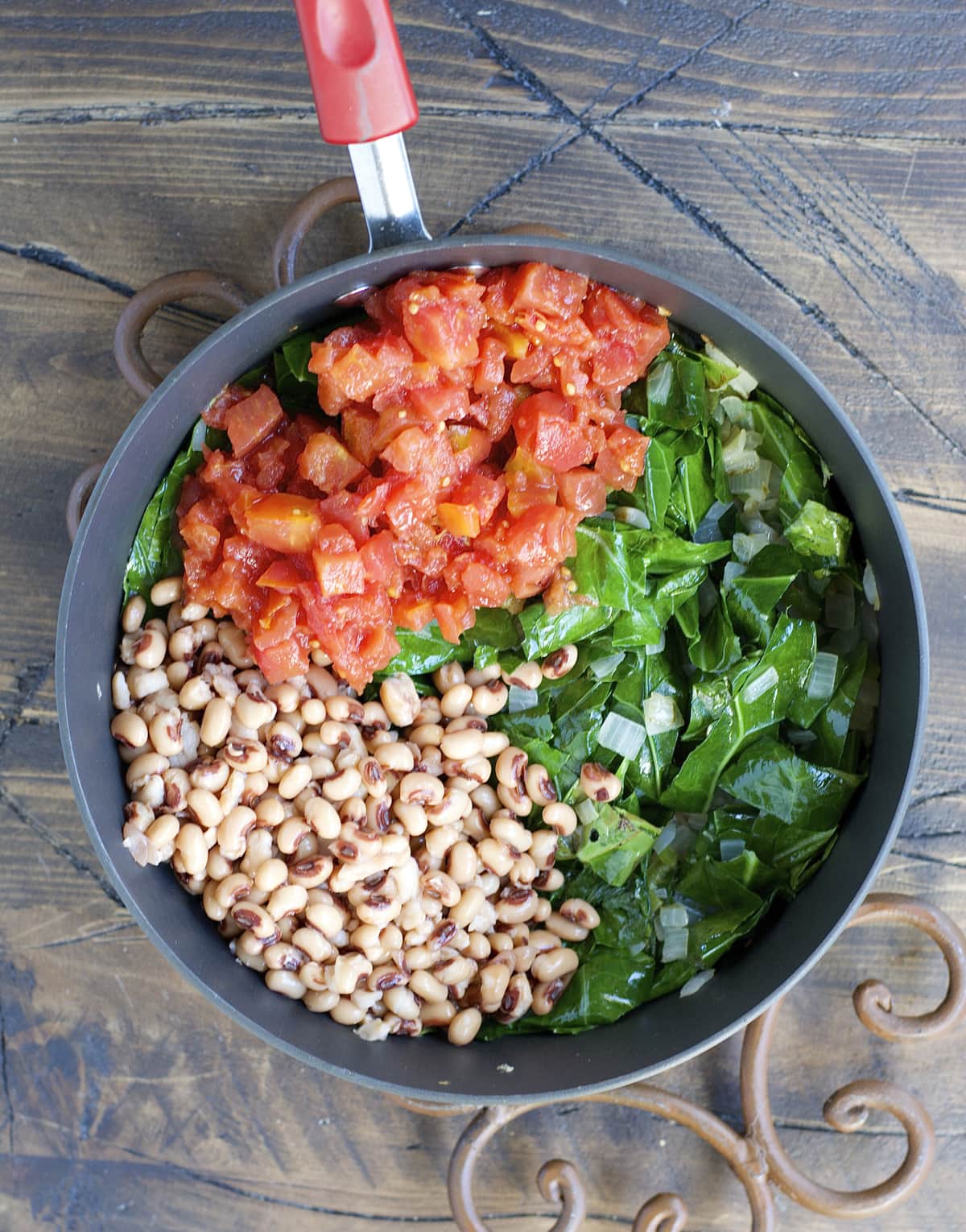 Crock Pot Black Eyed Peas and Collard Greens are the ultimate Southern comfort food! Tender greens, salty ham, and spicy jalapenos make the absolute best slow cooker meal.