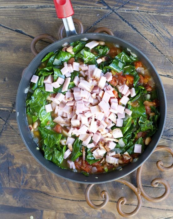 Crock Pot Black Eyed Peas and Collard Greens are the ultimate Southern comfort food! Tender greens, salty ham, and spicy jalapenos make the absolute best slow cooker meal.