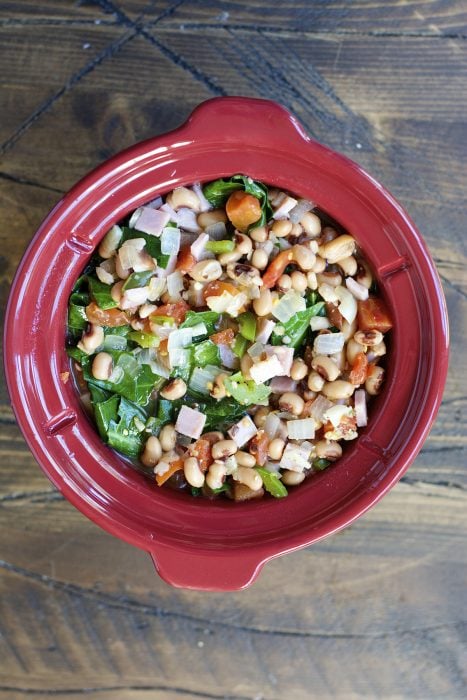 Crock Pot Black Eyed Peas and Collard Greens are the ultimate Southern comfort food! Tender greens, salty ham, and spicy jalapenos make the absolute best slow cooker meal.