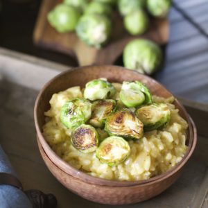 Crispy pan seared Brussels Sprouts are laid atop a bed of creamy Parmesan and white wine risotto! An ultra comforting Winter dish!