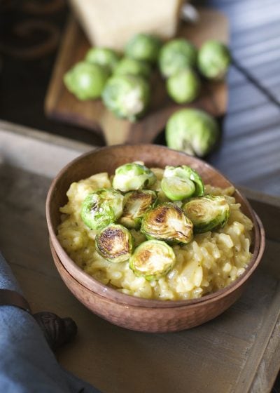 Crispy pan seared Brussels Sprouts are laid atop a bed of creamy Parmesan and white wine risotto! An ultra comforting Winter dish!