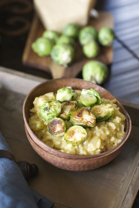 Crispy pan seared Brussels Sprouts are laid atop a bed of creamy Parmesan and white wine risotto! An ultra comforting Winter dish!