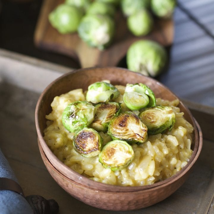 Crispy pan seared Brussels Sprouts are laid atop a bed of creamy Parmesan and white wine risotto! An ultra comforting Winter dish!