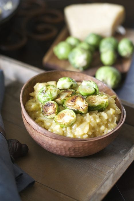 Crispy pan seared Brussels Sprouts are laid atop a bed of creamy Parmesan and white wine risotto! An ultra comforting Winter dish!