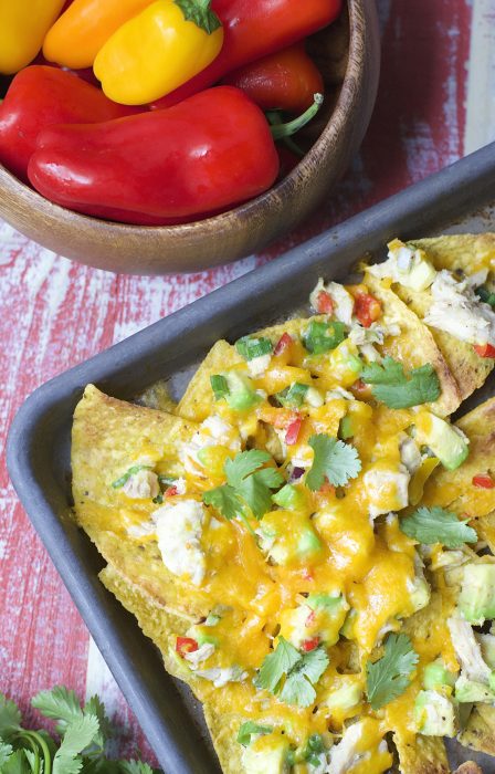 Crispy nachos are topped with fresh avocado, sweet peppers, tuna and lime juice! These healthy and easy Tuna Nachos are the perfect easy weeknight meal!