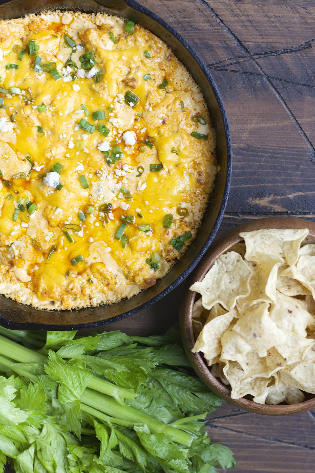 This Blue Cheese Bacon Buffalo Chicken Dip is packed with tangy buffalo sauce, crunchy celery, salty bacon, loads of cheese and shredded chicken! This is the ultimate game day appetizer!