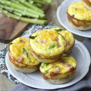 Mini Quiche cups are packed with tender ham, fresh asparagus and sharp cheddar cheese for a easy Spring brunch!