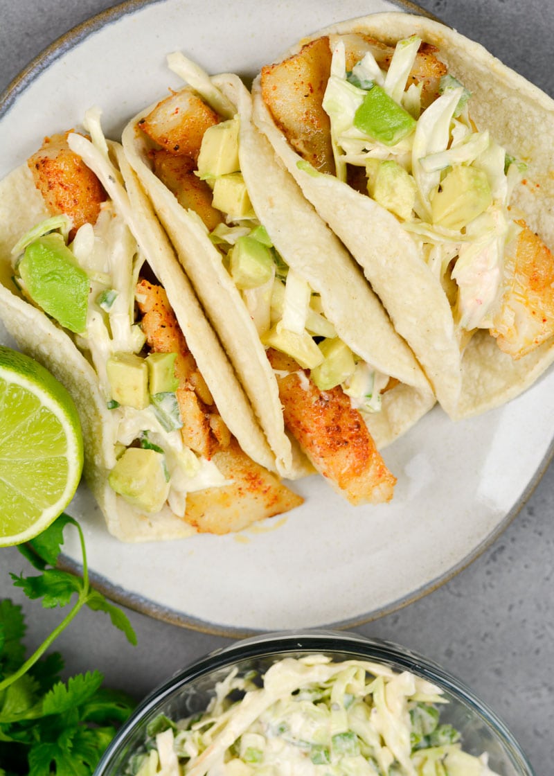 These light and healthy Easy Fish Tacos with Zesty Slaw are packed with flavor and ready in just 20 minutes! This dish is gluten free and perfect for busy weeknights!