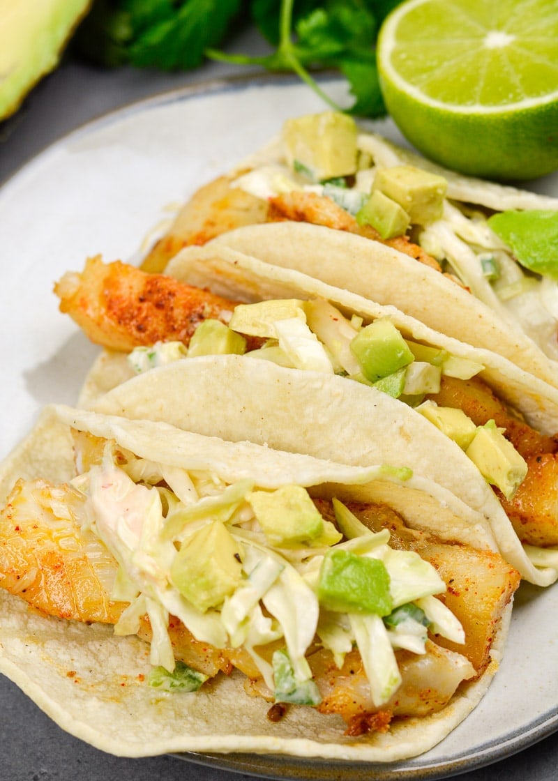 These light and healthy Easy Fish Tacos with Zesty Slaw are packed with flavor and ready in just 20 minutes! This dish is gluten free and perfect for busy weeknights!