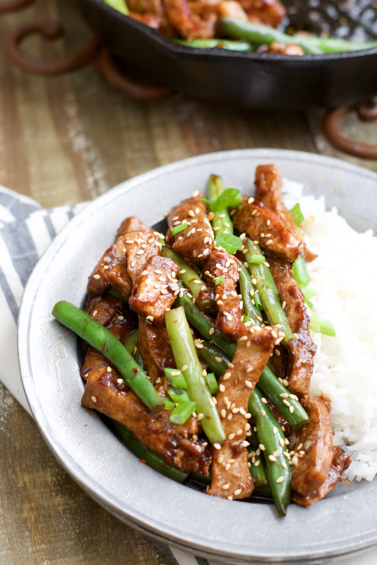 A plate of rice and sesame pork stir fry. 