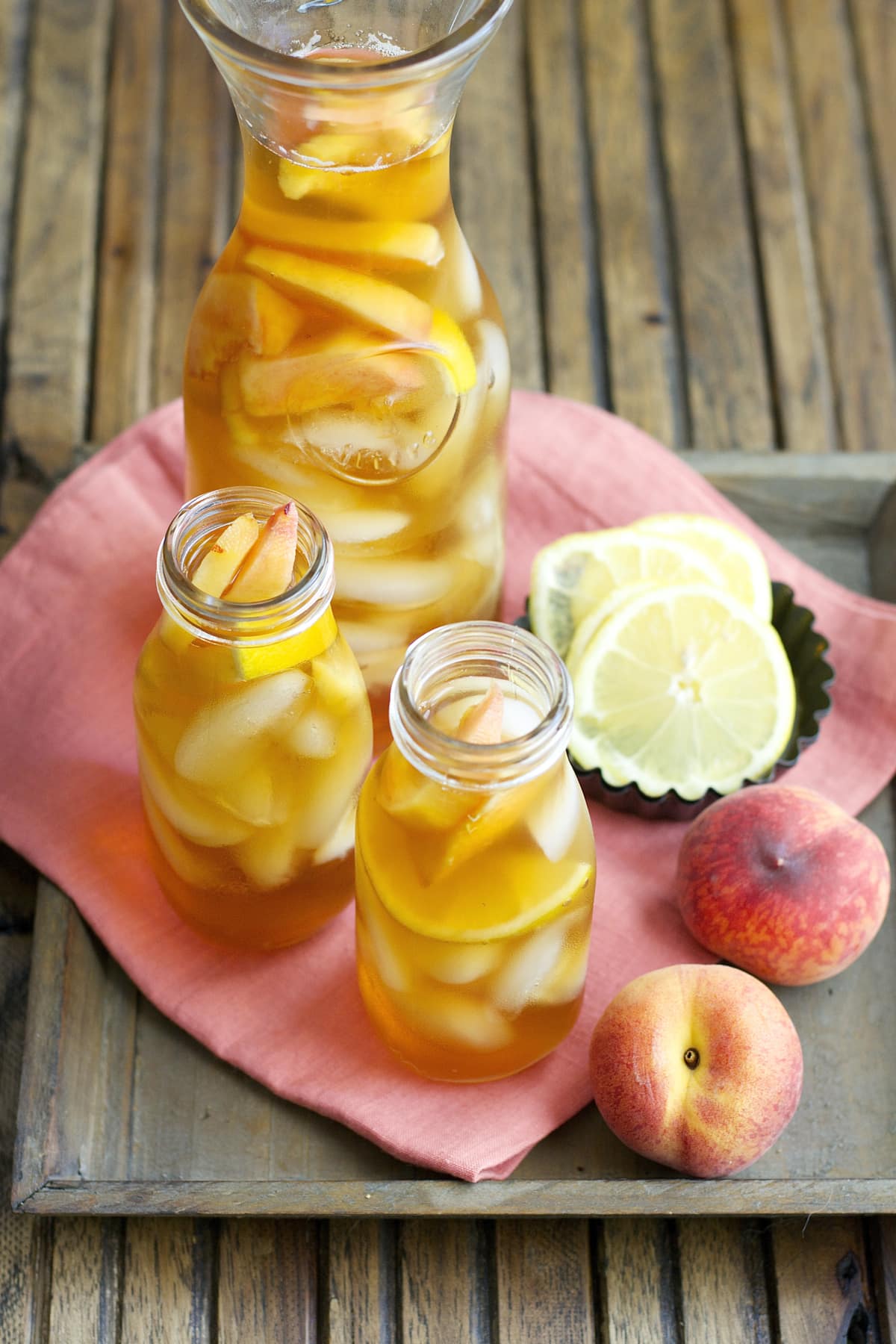 Sweet and refreshing Vanilla Peach Tea is the perfect Summer drink! Serve with fresh peach and lemon slices for simple Summer entertaining!