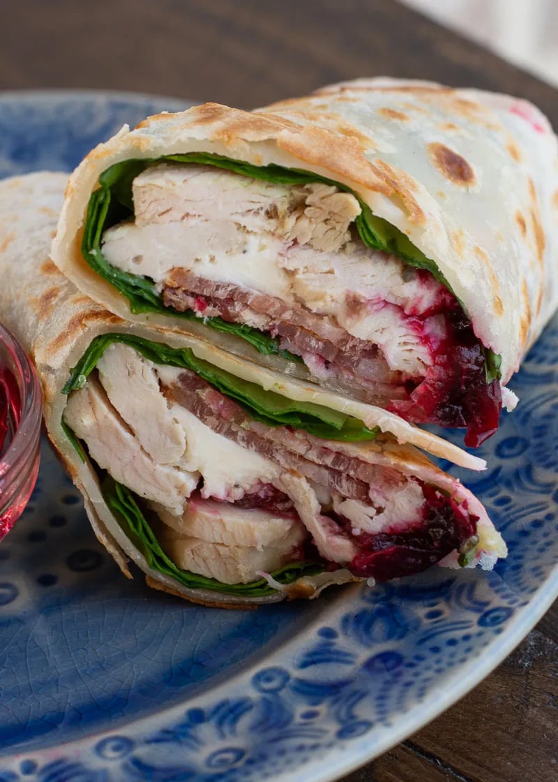 These Leftover Turkey Wraps include cranberry sauce, brie, bacon, and spinach for a healthy lunch! This is the perfect recipe for using holiday leftovers but it’s great with chicken, too.