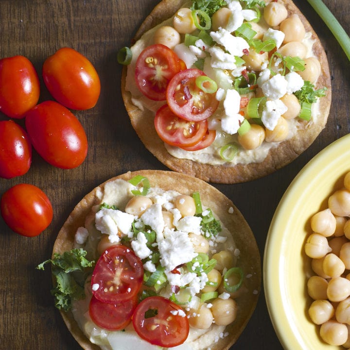 These Mediterranean Hummus Tostadas are an effortless idea for entertaining! Crispy tostadas are topped with creamy hummus, tender chick peas and fresh veggies!