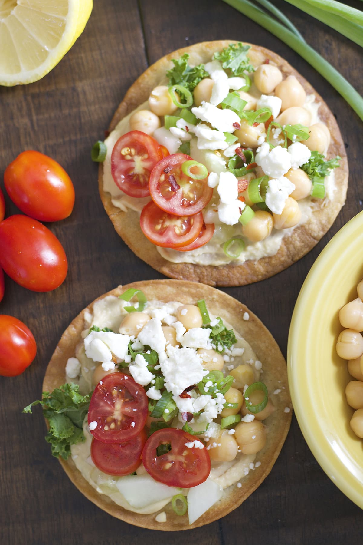 These Mediterranean Hummus Tostadas are an effortless idea for entertaining! Crispy tostadas are topped with creamy hummus, tender chick peas and fresh veggies!