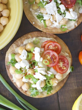 These Mediterranean Hummus Tostadas are an effortless idea for entertaining! Crispy tostadas are topped with creamy hummus, tender chick peas and fresh veggies!
