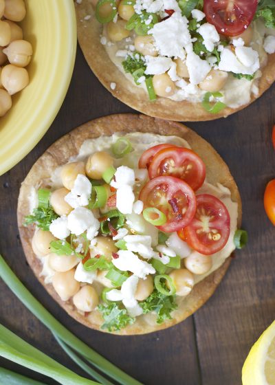 These Mediterranean Hummus Tostadas are an effortless idea for entertaining! Crispy tostadas are topped with creamy hummus, tender chick peas and fresh veggies!