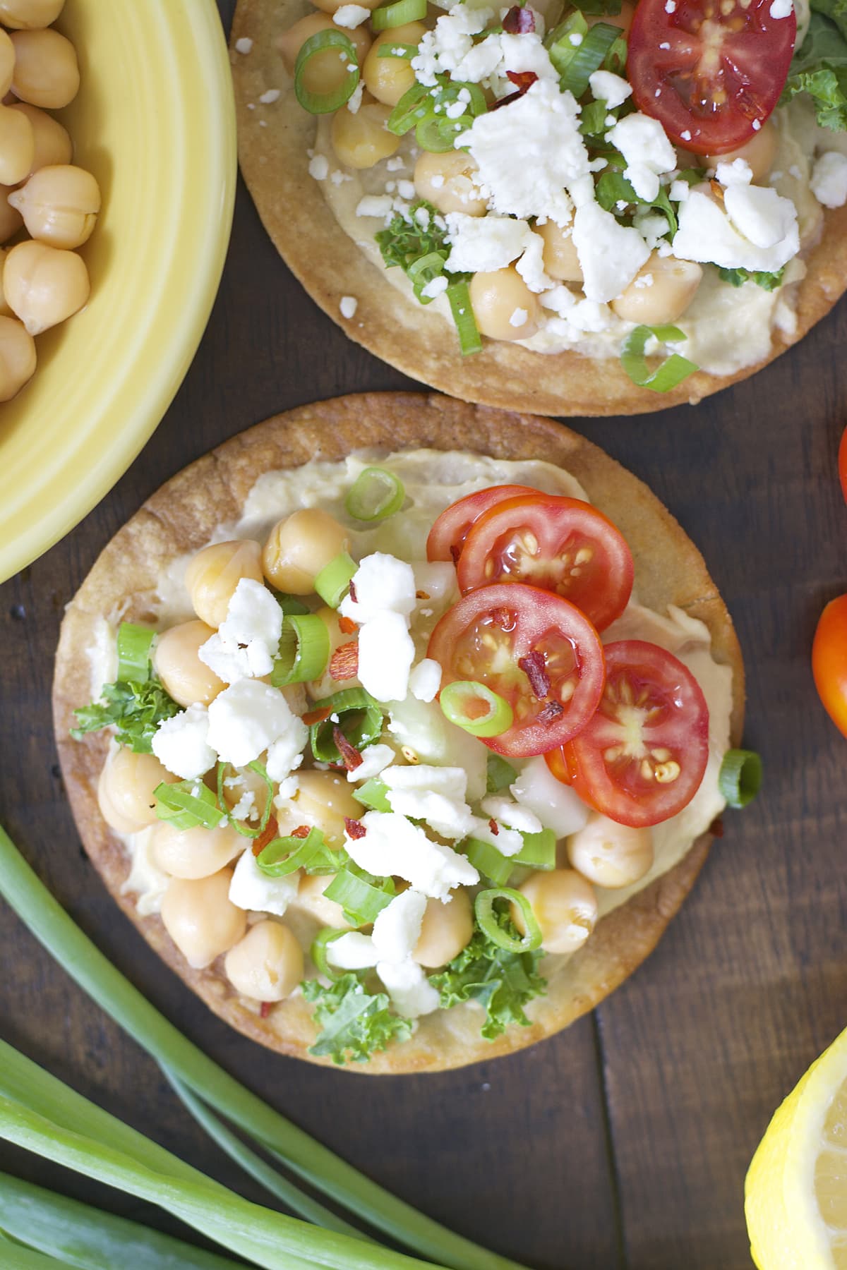 These Mediterranean Hummus Tostadas are an effortless idea for entertaining! Crispy tostadas are topped with creamy hummus, tender chick peas and fresh veggies!