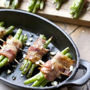 Tender green beans are marinated and wrapped in bacon, grilled to perfection and topped with tangy bleu cheese! This is an incredible Summer side dish you will love!