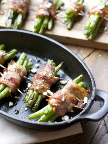 Tender green beans are marinated and wrapped in bacon, grilled to perfection and topped with tangy bleu cheese! This is an incredible Summer side dish you will love!