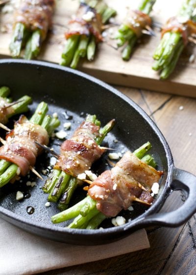 Tender green beans are marinated and wrapped in bacon, grilled to perfection and topped with tangy bleu cheese! This is an incredible Summer side dish you will love!