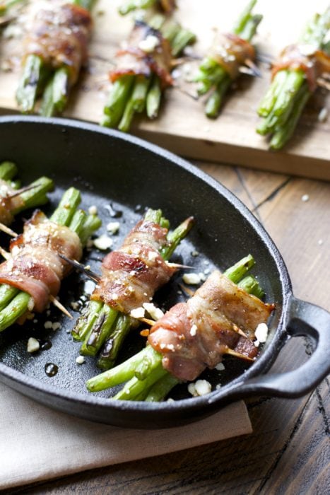 bacon wrapped green beans in a cast iron pan