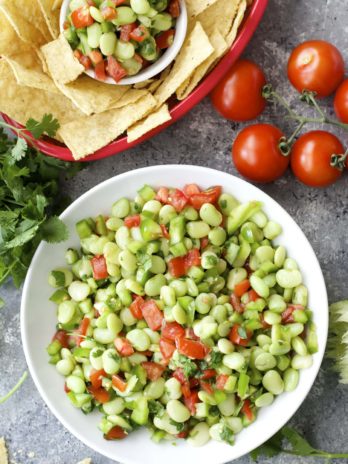 Tender Lime Beans are combined with tomatoes and peppers and tossed in a zesty sauce! Grab some chips and get to snacking! You will love this easy Lima Bean Salsa!