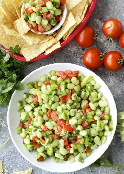 Tender Lime Beans are combined with tomatoes and peppers and tossed in a zesty sauce! Grab some chips and get to snacking! You will love this easy Lima Bean Salsa!