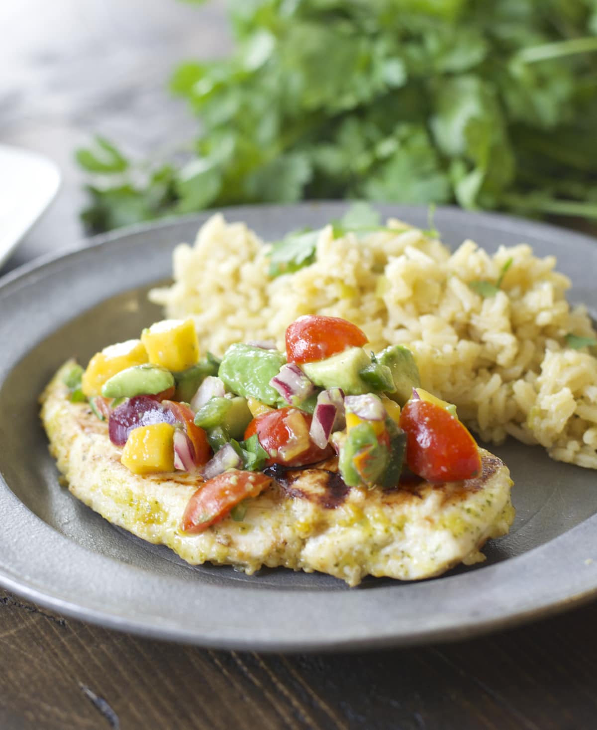 This Sweet and Spicy Habanero Chicken with Mango Salsa is grilled to perfection and packed with flavor!