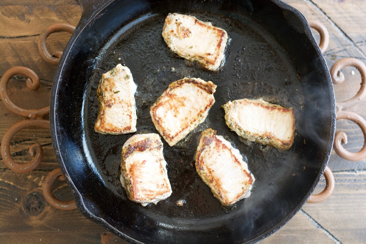 Make these easy one pan Garlic Herb Pork Medallions with Tuscan White Beans for a hearty comforting dish ready in under 30 minutes!