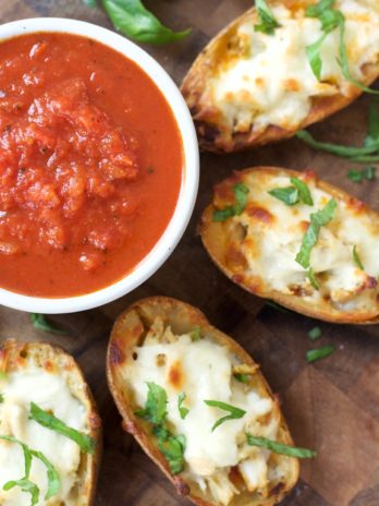 You can make these Chicken Parmesan Stuffed Potato Skins with just five simple ingredients! This easy recipe will become a family favorite!