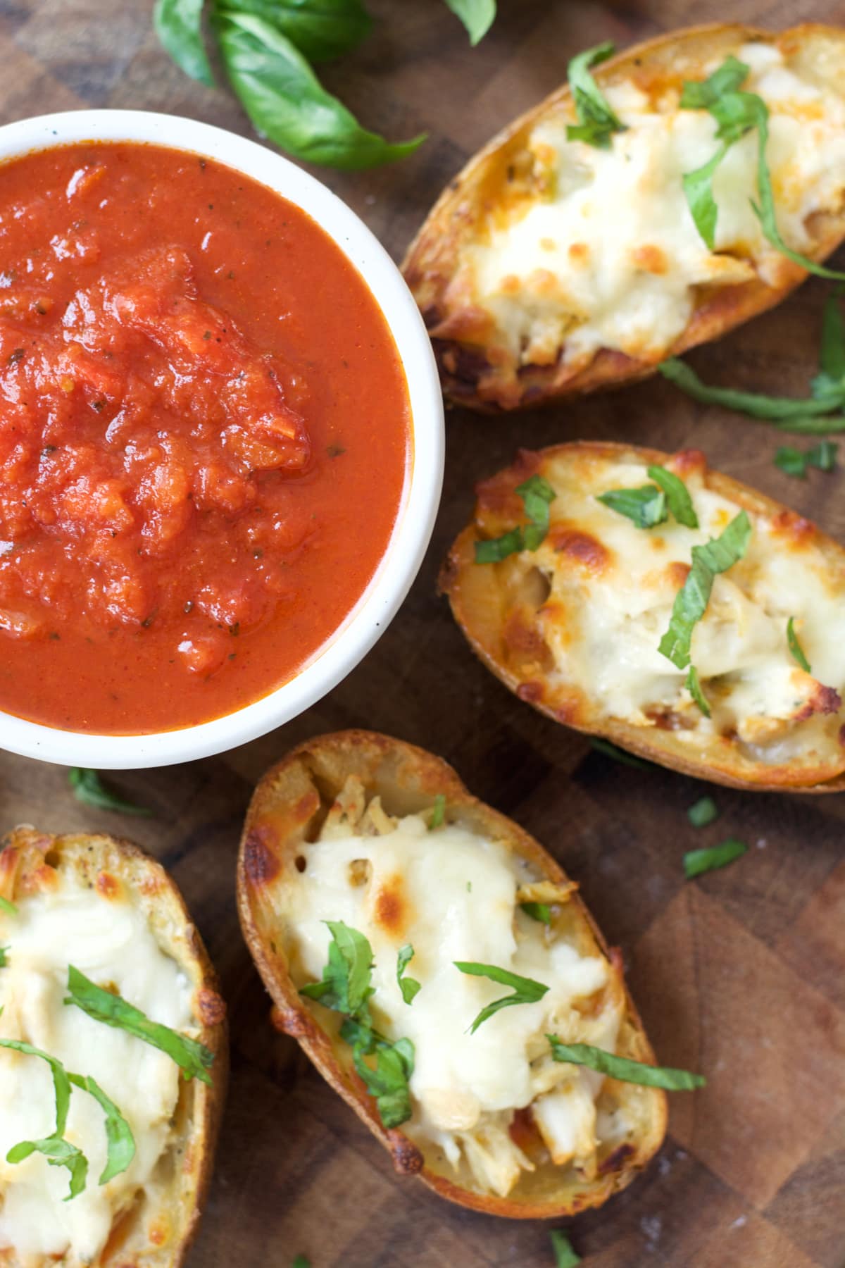 You can make these Chicken Parmesan Stuffed Potato Skins with just five simple ingredients! This easy recipe will become a family favorite!