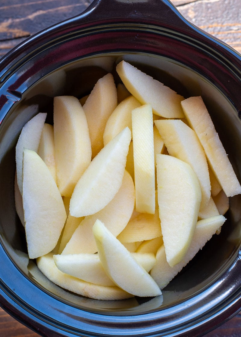 These Slow Cooker Pumpkin Spiced Apples are the ultimate autumn comfort food! Serve these warm spiced apples with vanilla ice cream and toasted pecans for the perfect Fall dessert!